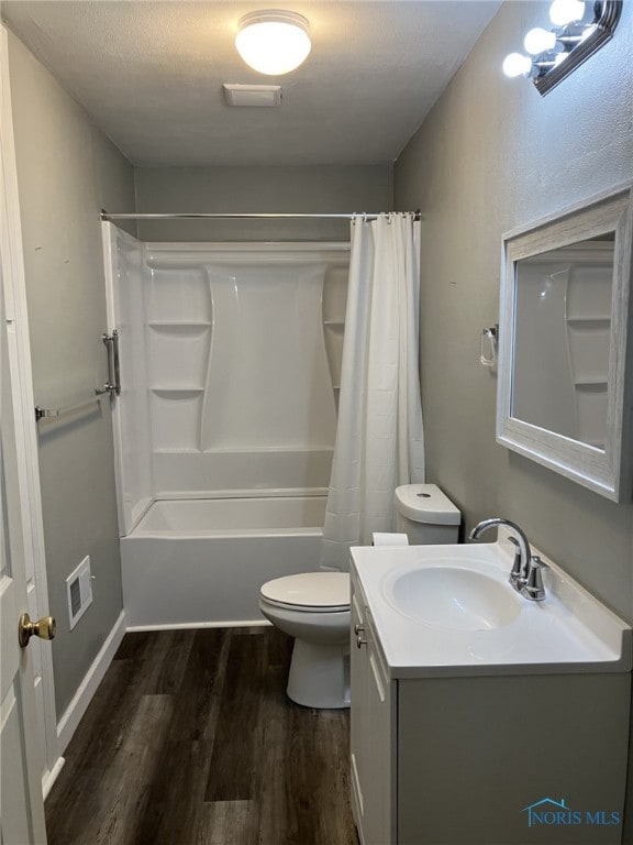 full bathroom with hardwood / wood-style flooring, vanity, toilet, and shower / bath combo with shower curtain