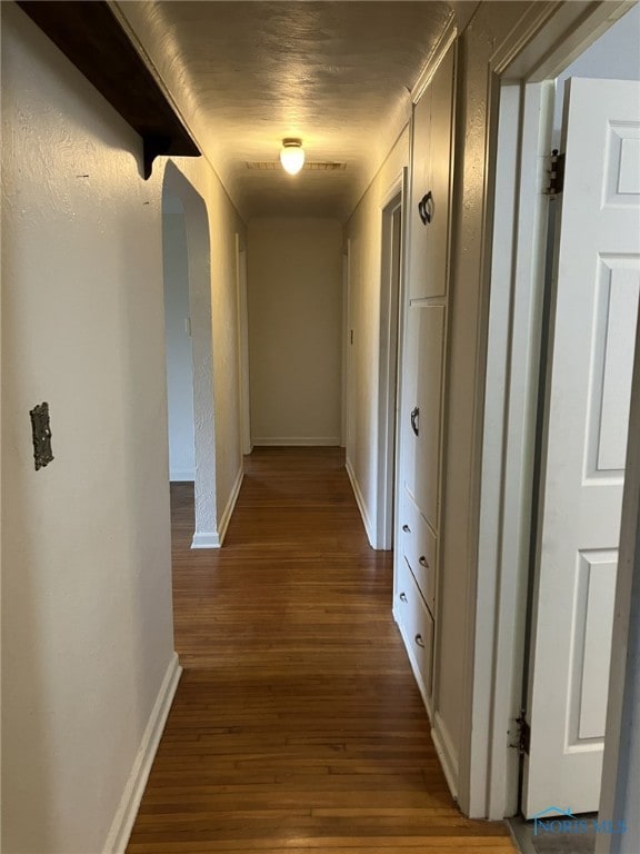 corridor with dark wood-type flooring