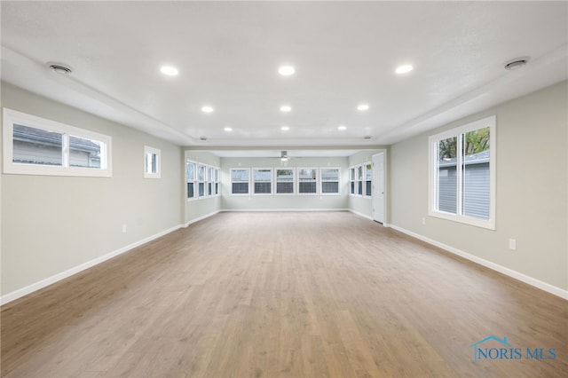 unfurnished living room featuring ceiling fan and light wood-type flooring