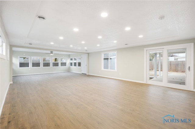 unfurnished living room with light hardwood / wood-style floors and ceiling fan