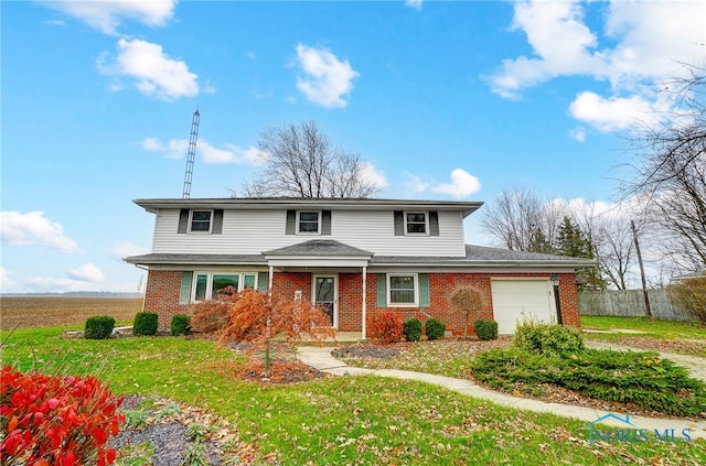 view of property featuring a garage and a front lawn