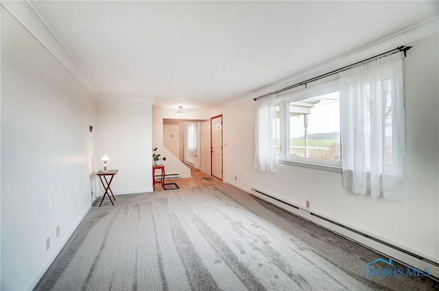 unfurnished room featuring crown molding, light colored carpet, and a baseboard heating unit