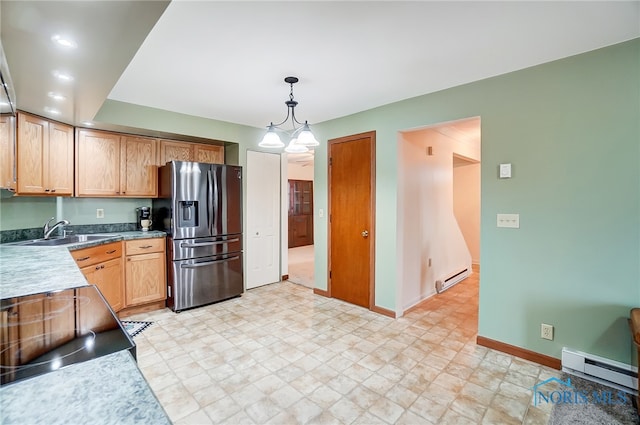 kitchen featuring decorative light fixtures, stainless steel fridge with ice dispenser, a chandelier, and a baseboard radiator