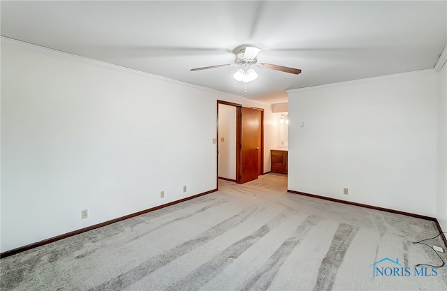 carpeted empty room featuring ceiling fan and ornamental molding