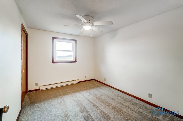 carpeted spare room featuring baseboard heating and ceiling fan