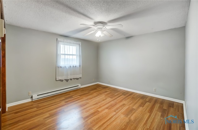 empty room with ceiling fan, light hardwood / wood-style flooring, a textured ceiling, and a baseboard heating unit