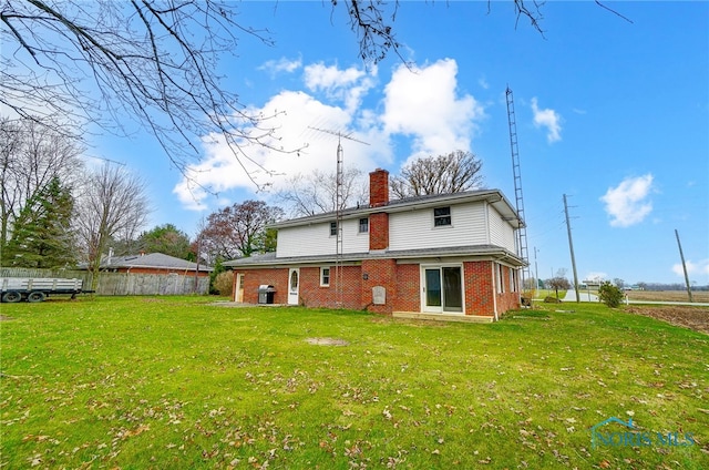 rear view of property with a lawn