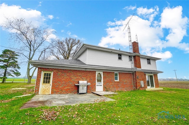 back of house featuring a patio and a lawn