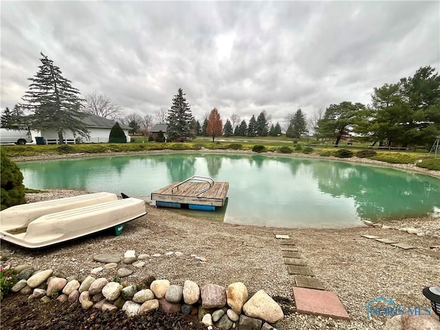 view of swimming pool featuring a water view