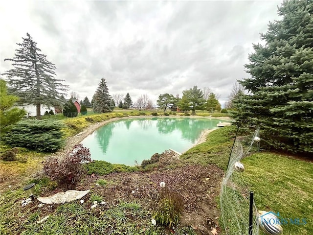 view of swimming pool featuring a water view