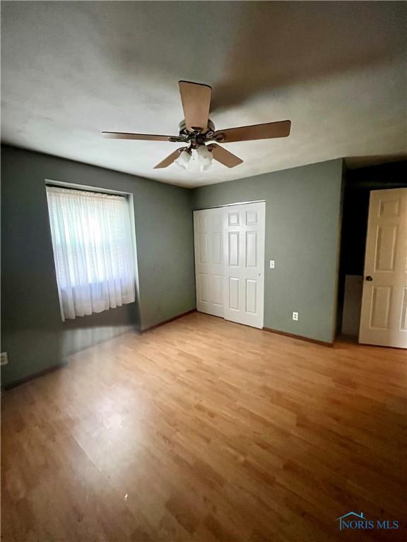 unfurnished bedroom featuring light hardwood / wood-style floors and ceiling fan