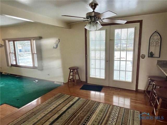 doorway to outside featuring french doors, ceiling fan, and wood-type flooring