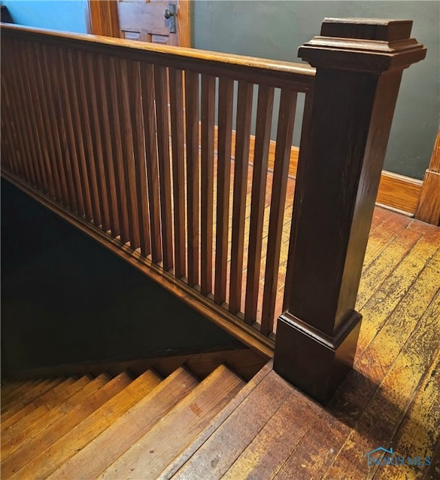 stairway featuring wood-type flooring