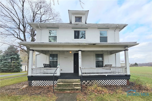 view of front of property featuring a porch and a front yard