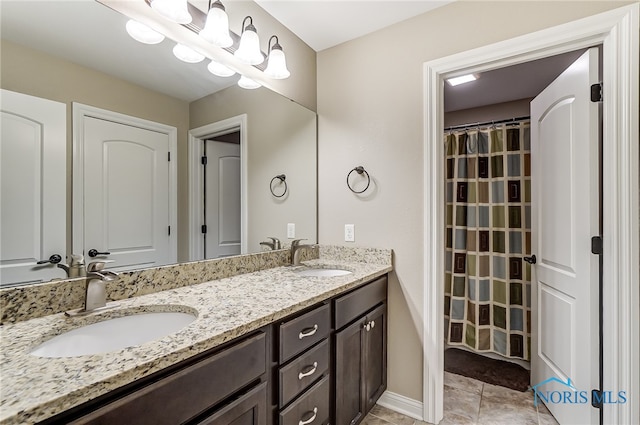 bathroom with tile patterned floors and vanity