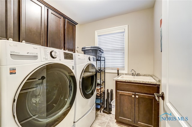 laundry area with washer and dryer, cabinets, light tile patterned floors, and sink