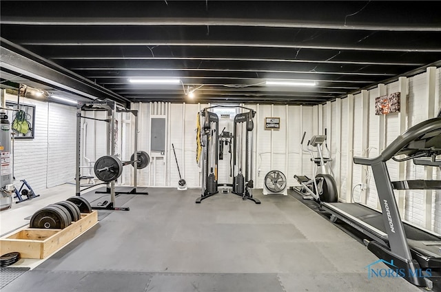 exercise area featuring electric panel and water heater