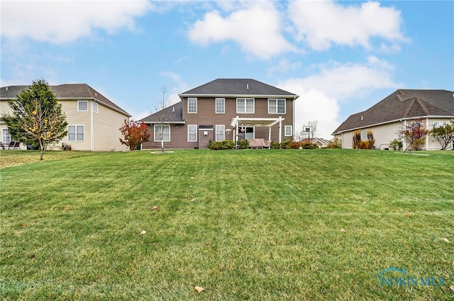 back of property featuring a pergola and a lawn