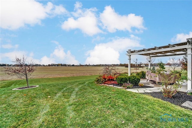 view of yard with a pergola and a rural view