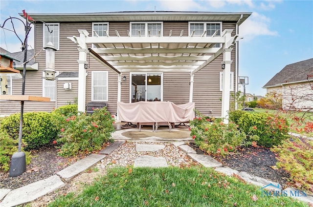 rear view of property with a pergola