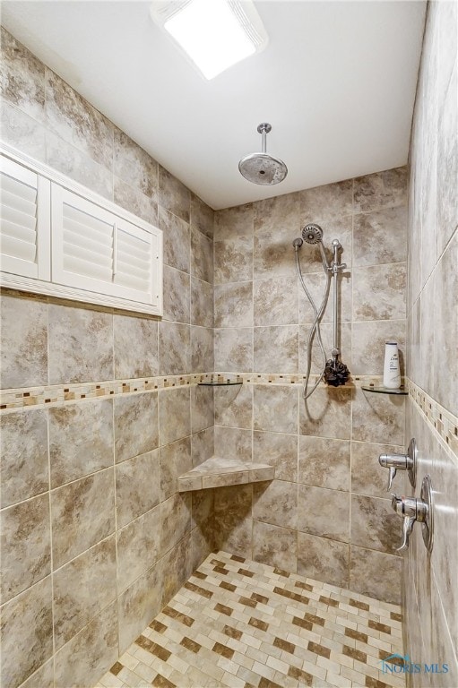 bathroom with tiled shower