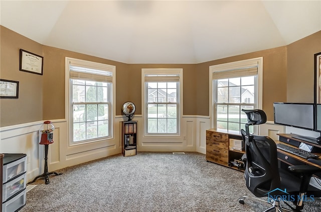 carpeted office space featuring plenty of natural light and vaulted ceiling