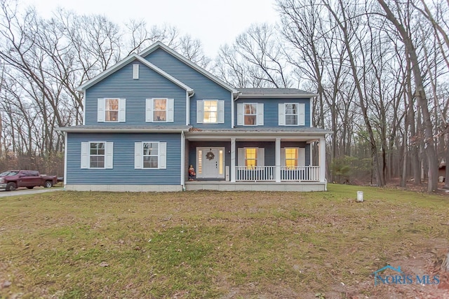 view of front of property with covered porch and a front lawn