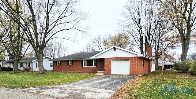 ranch-style house with a garage and a front lawn