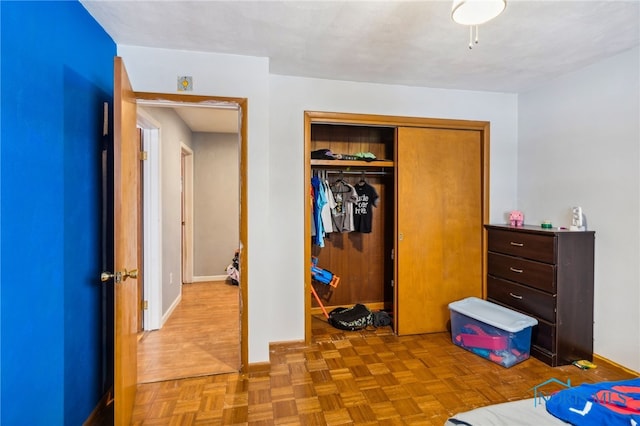 bedroom with a closet and light parquet flooring