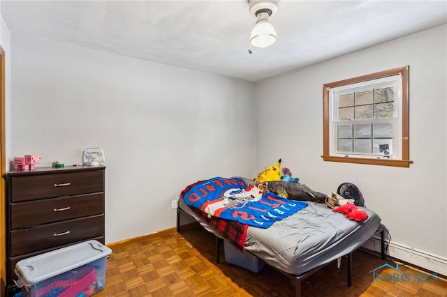 bedroom with baseboard heating and parquet flooring