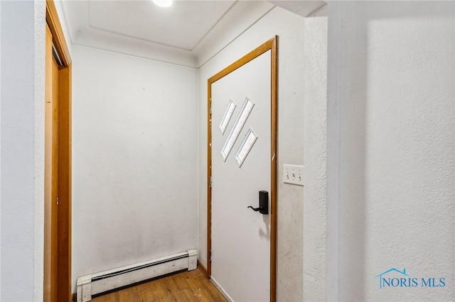 entryway featuring wood-type flooring and a baseboard radiator