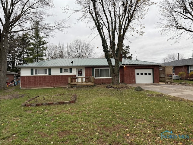 single story home featuring a front lawn and a garage