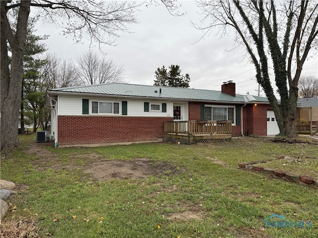 single story home with a wooden deck, central AC unit, and a front yard