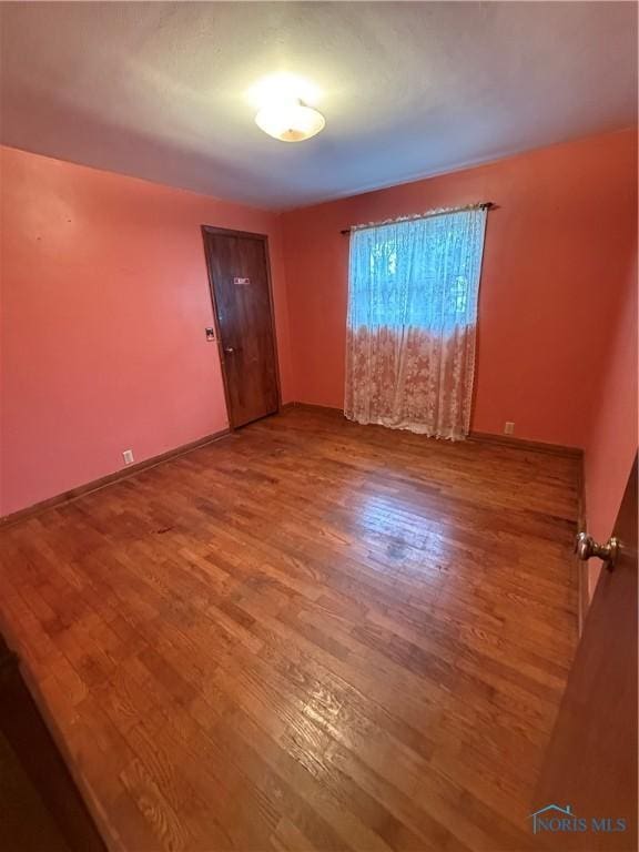 unfurnished room featuring wood-type flooring