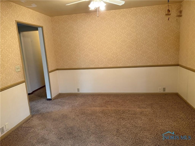 empty room with ceiling fan and carpet floors