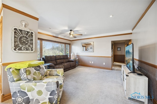 living room with ceiling fan, light colored carpet, and ornamental molding