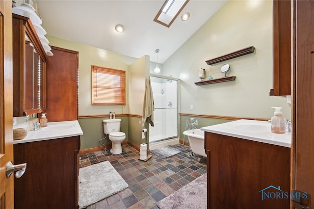 full bathroom with vanity, separate shower and tub, toilet, and lofted ceiling with skylight