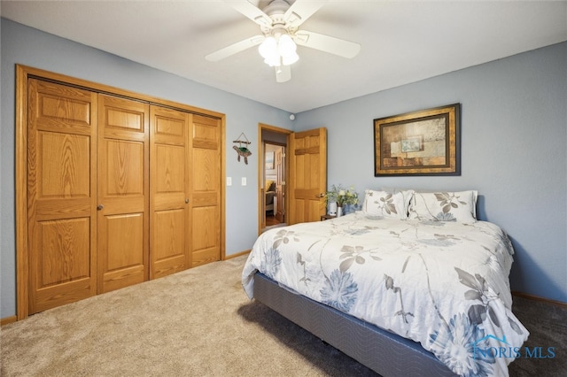 carpeted bedroom with a closet and ceiling fan