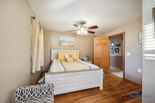 bedroom with dark hardwood / wood-style flooring and ceiling fan