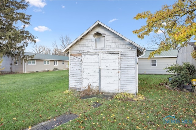 view of outbuilding with a yard