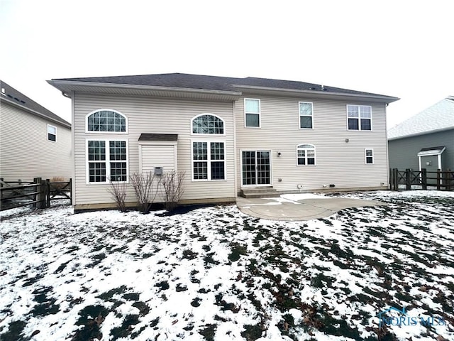 snow covered house with a patio area