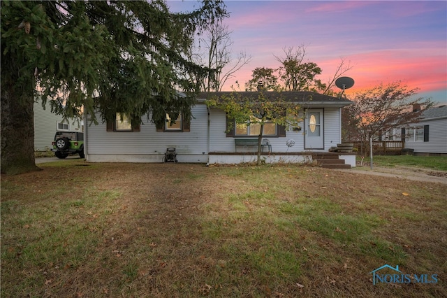 view of front of property with a yard