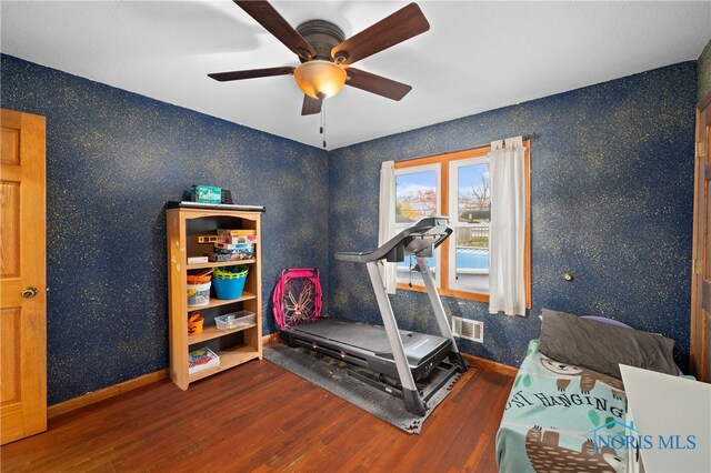 workout room featuring ceiling fan and wood-type flooring