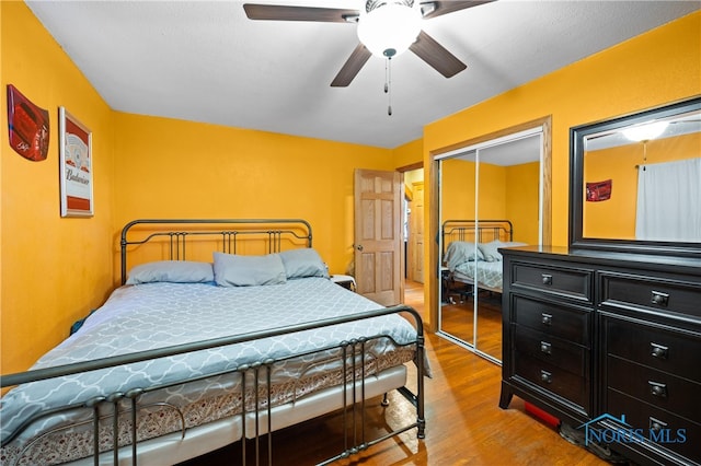 bedroom with a closet, ceiling fan, and light hardwood / wood-style flooring