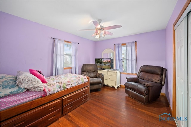 bedroom with ceiling fan, a closet, and dark hardwood / wood-style floors