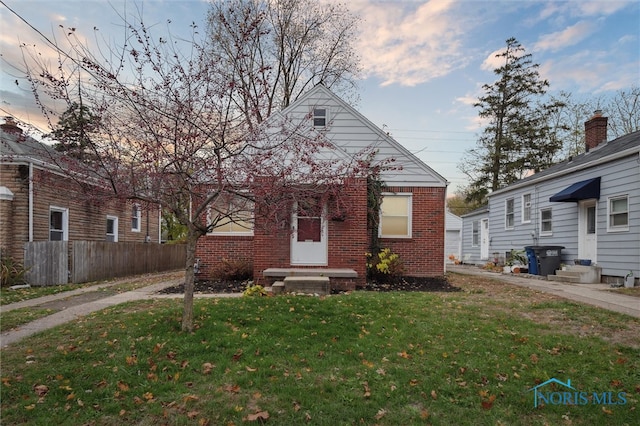 bungalow-style house with a yard