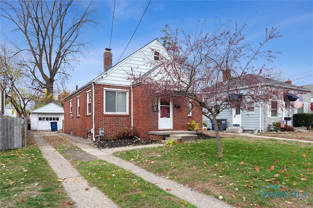 bungalow-style house with an outdoor structure, a front yard, and a garage