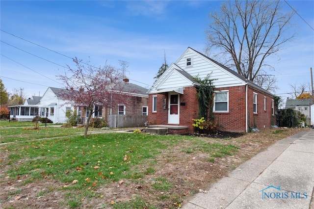 bungalow-style house with a front lawn