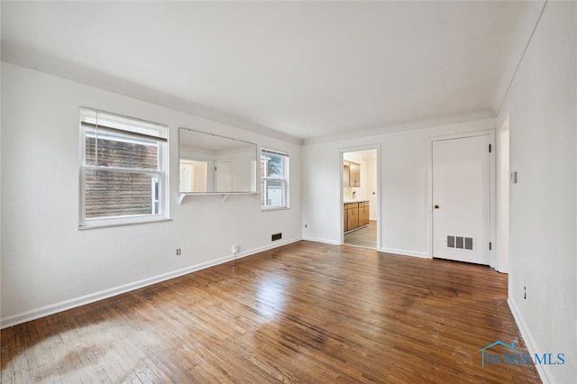 spare room with hardwood / wood-style flooring