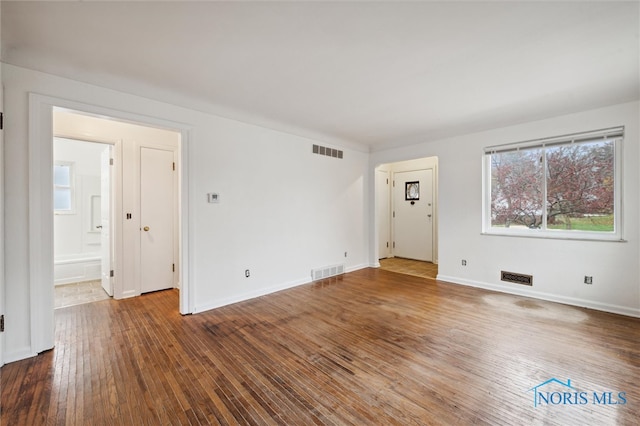 unfurnished room with hardwood / wood-style floors